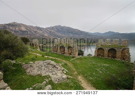 Ruined Walls Of Castle Over The Lake Bafa In A Nature Reserve Situated In Southwestern Turkey
