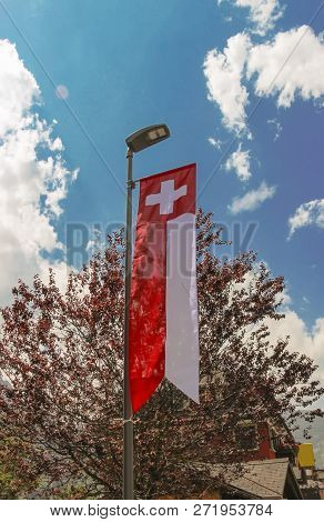 Swiss National Flag Hung From A Street Lamp At Grindelwald