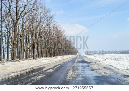 Melting Snow Outside Of The City On The Country Road. Weather Forecast For Early Spring. Melting Sno