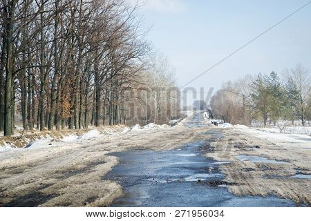 Melting Snow Outside Of The City On The Country Road. Weather Forecast For Early Spring. Melting Sno