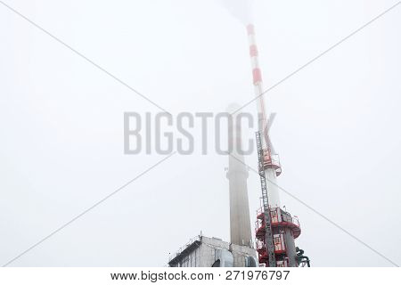 Old A New Chimneys At Heating Plant Covered In Fog, Cloudy Winter Day, Low Angle View, Energy Produc