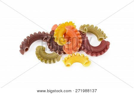 Several Uncooked Colored Short Curved And Ruffled Pasta Also Known As Creste Di Gallo Pasta Close-up
