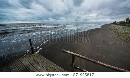 Rusty Bridge Stretching Into The Lifeless Sea, Caspian Sea Under Blue Sky In Early September, Snag O