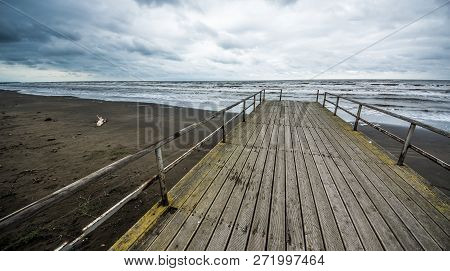Rusty Bridge Stretching Into The Lifeless Sea, Caspian Sea Under Blue Sky In Early September, Snag O