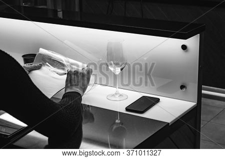 Sommelier, Cavist. Wine Glass In Hand Checking Wine On White Background. Wine School. Wine Tasting.
