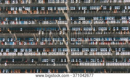 Huge Parking With New Cars In The Territory Of An Automobile Factory, Aerial View. Overproduction Of