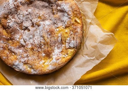 Delicious Homemade Pie With Apples And Cinnamon On Yellow Background