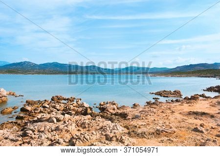 a view of the rock formations in La Tonnara, on the Southern coast of Corsica, France, with the calm Mediterranean sea in the background