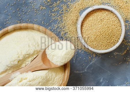 Bowl Of Raw Amaranth Flour With A Spoon And Bowl Of Amaranth Seeds On A Grey Table Top View