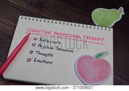 Cognitive Behavioral Therapy Write On A Book With Keywords Isolated Wooden Table.