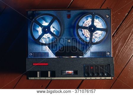 reel to reel audio tape recorder with blue led light strip. VU meter with 