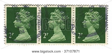 UK-CIRCA 1990:A stamp printed in UK shows image of Elizabeth II is the constitutional monarch of 16 sovereign states known as the Commonwealth realms,  in green, circa 1990.