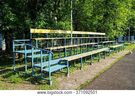Empty Spectator Stand On An Amateur Soccer Field. Wooden Grandstand At The School Stadium. Sports Gr