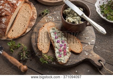 Nettle Butter Slathered Over A Slice Of Bread, With Fresh Lungwort Flowers