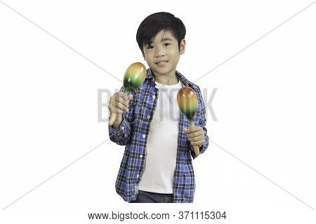 Portrait Of A Cute Asian Elementary School Boy Wearing A Jeans And A Plaid Shirt With Maracus, A Mus