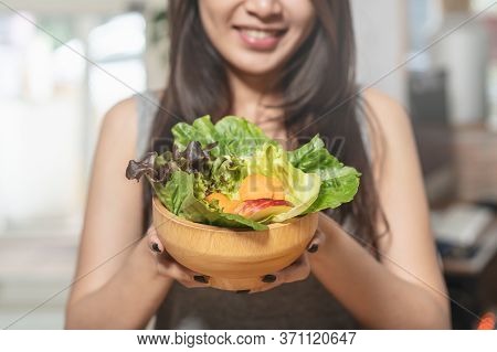 Eat High Fiber And Low Calories Foods For Good Health.young Woman Eating Bowl Of Fresh Salad And Pur