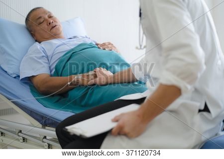 Doctor Touching Hands To Encouragement Mental Of Elderly Patient After Surgery At Bed In Hospital.