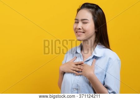 Appreciated Expression. Pleased Asian Woman Keeping Hands On Chest And Closing Her Eyes Isolated On 