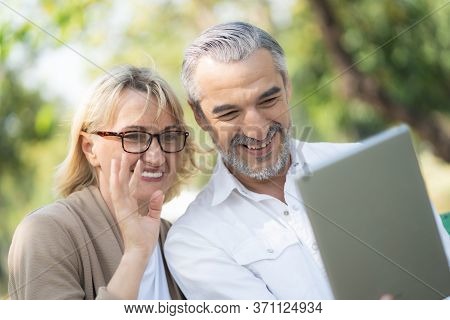 Technology Connect And Modern Elderly Lifestyles Concept. Aged Senior Couple Waving Hands Greeting G
