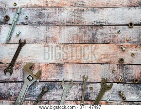 Tools For Threaded Connections And Fasteners. Wrenches, Bolts And Nuts On Wooden Boards. Space For T