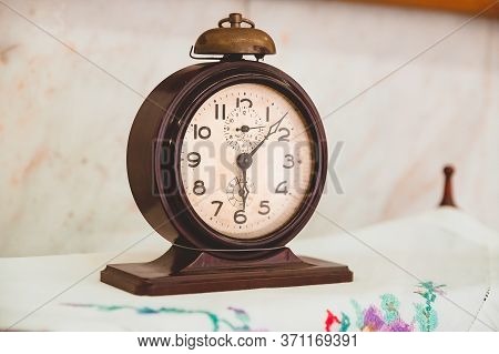 Izhevsk, Russia - July 7, 2017 : Old Alarm Clock Is On The Nightstand. Soviet Antiques Produced By T