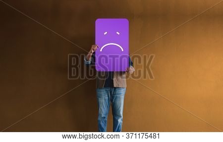 Customer Experiences Or Human Emotional Concept. Sadness Person Raised Up Paper Card To Showing A Up
