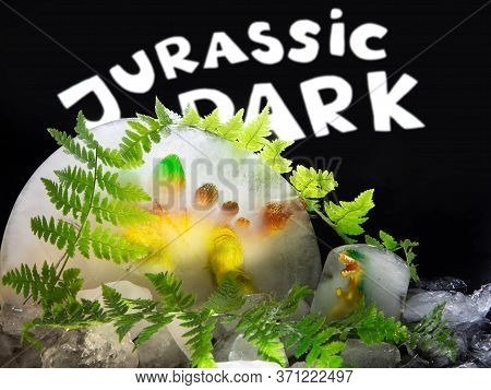 Toy Dinosaurs In Ice. Fern Leaves. Jurassic Park.