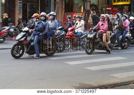 Hoi An, Vietnam - March 20, 2016: A Lot Of Asian People Ride Motorcycles