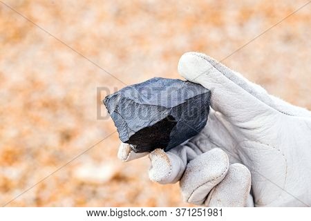 Miner Hand Holding Iron Stone, Metallic Iron Pyrite, Steel, Used In Heavy Industrial Production. Min