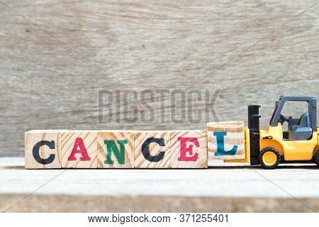 Toy Forklift Hold Letter Block L To Complete Word Cancel On Wood Background