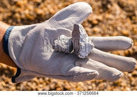 Hand Holding Silver Stones, Silver Ore. Gemstone Mining Concept