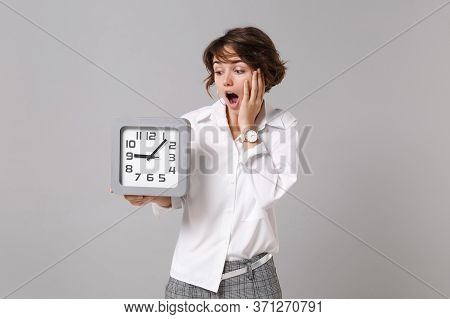 Shocked Young Business Woman In White Shirt Posing Isolated On Grey Wall Background Studio Portrait.