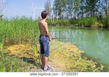 village boy fishing with a rod in the river