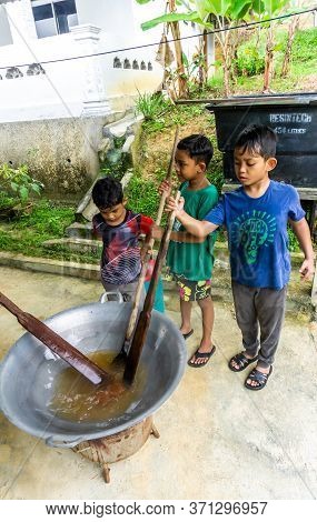 Cooking Traditional Malaysian Sweet Desert, Dodol By The Villagers During Hari Raya.