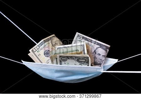 Medical Face Mask And Money On A Black Background. World Coronavirus Epidemic And Economic Losses Co