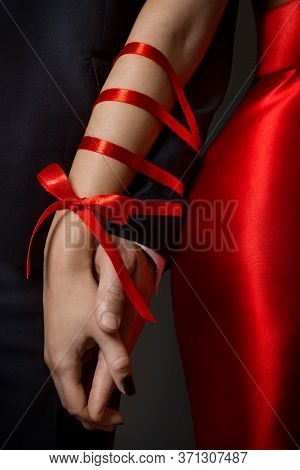 Couple Tied Hands, Woman And Man Arms Bonded Together By Red Ribbon, Relationship Concept