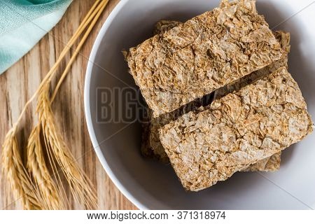 Cereal Breakfast Bars In Breakfast Bowl With Wheat Ears Next To It - Close Up Top View Photo