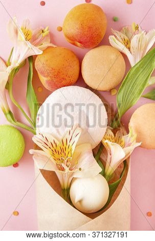 Beige And Green Macaroons, French Cookies, Meringues, Fresh Apricots, Alstroemeria Flowers In An Env
