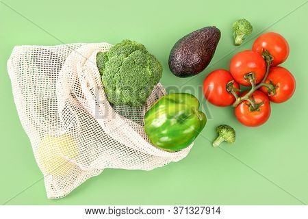 Eco Friendly Bag With Organic Vegetables On Green Background. Tomatoes, Pepper, Avocado, Broccoli In