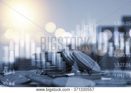 Blue Double Exposure Of Money Coins Stacking With Bar Graph For Financial And Investment Business Co
