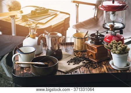 Cup Of Coffee, Beans Roating And Ingredients For Making Coffee  And Accessories On The Table Wooden