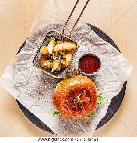 burger with tomato sauce and baked potato