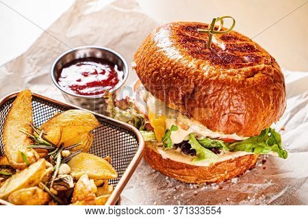burger with tomato sauce and baked potato