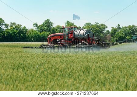 Self Propelled Sprayer Applying Pesticide To A Wheat Field