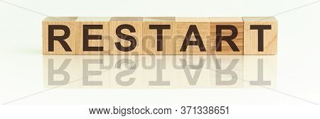 Wooden Blocks With The Text: Restart. The Text Is Written In Black Letters And Is Reflected In The M