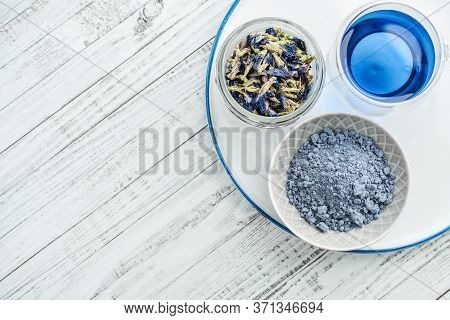 Organic Blue Tea Anchan, Clitoria, Butterfly Pea In Glass With Dried Clitoria Flowers And Blue Match