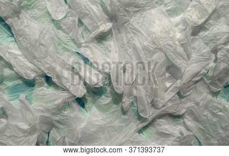 Vinyl Powder Free Transparent Gloves. Top View. Background Made Of Many Medical Latex White Gloves. 