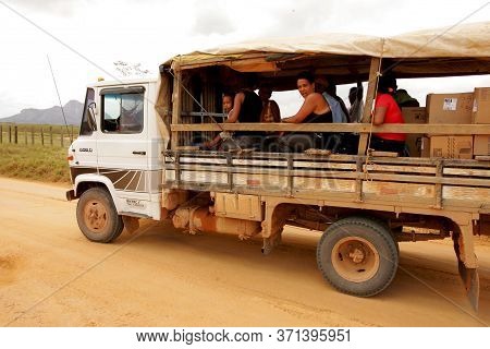Itamaraju, Bahia Brazil - September 23, 2010: People Are Seen In A Truck Body On A Dirt Road In The 