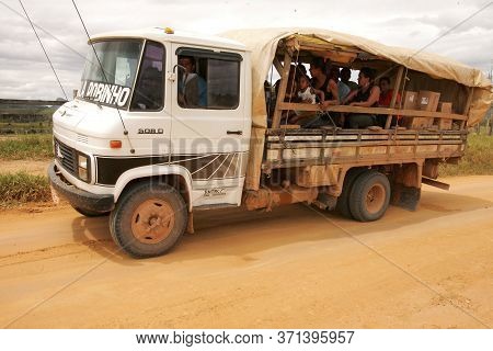 Itamaraju, Bahia Brazil - September 23, 2010: People Are Seen In A Truck Body On A Dirt Road In The 