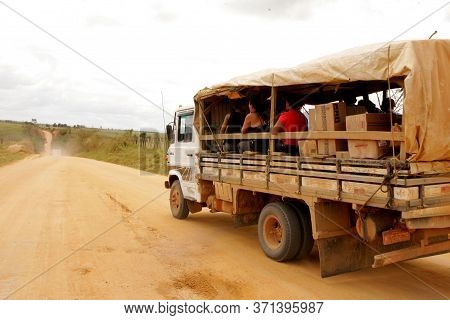 Itamaraju, Bahia Brazil - September 23, 2010: People Are Seen In A Truck Body On A Dirt Road In The 